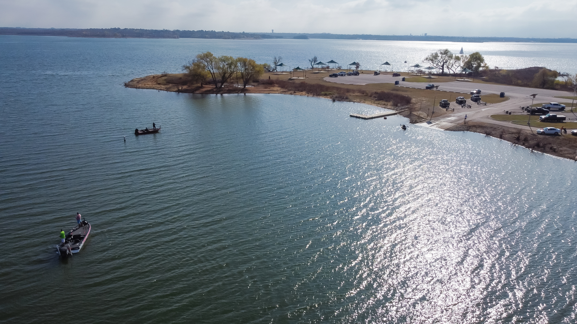 Aerial view low water boat ramp and motor boats with anglers fishing at Murrell Park, Lake Grapevine, Texas