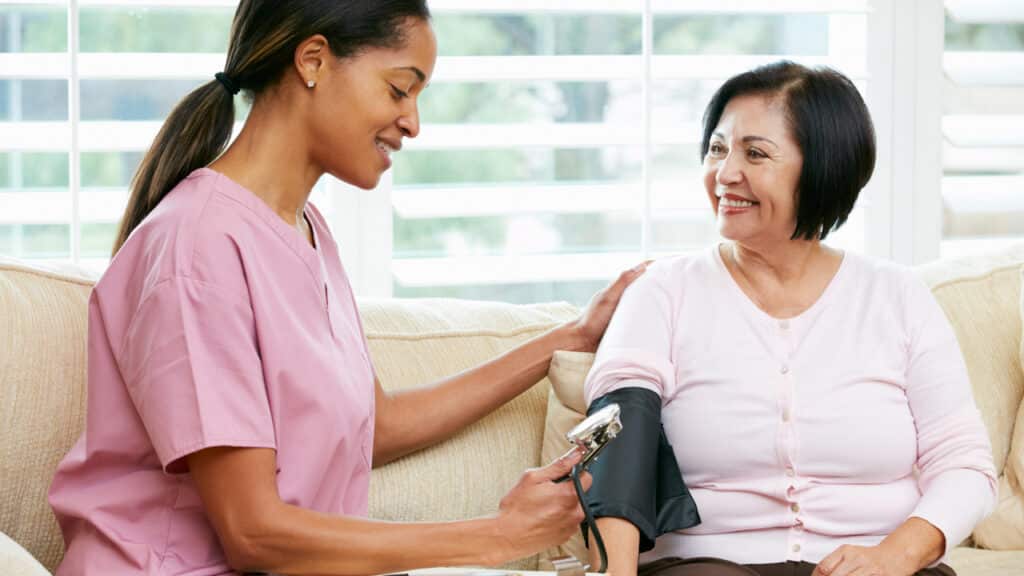 nurse checking a patients blood pressure while talking about weight loss medications and complications